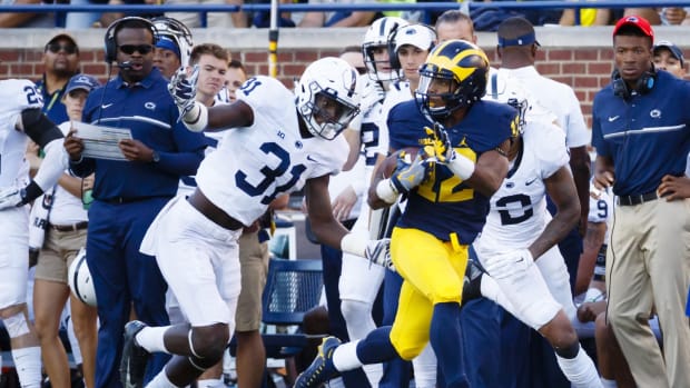 Sep 24, 2016; Ann Arbor, MI, USA; Michigan Wolverines running back Chris Evans (12) rushes past Penn State Nittany Lions linebacker Cameron Brown (31) in the second half at Michigan Stadium. Michigan 49-10.